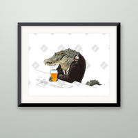 Crocodile art print in a black frame on a wall